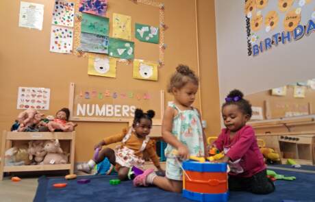 Group play, number boards, and toy instruments during circle time at Kid-Tastic Group play, number boards, and toy instruments during circle time at Kid-Tastic